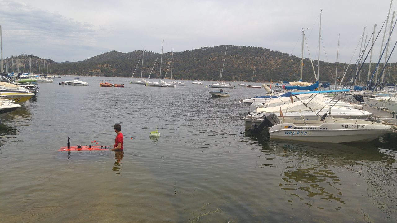 Deploying a submarine robot into the reservoir.