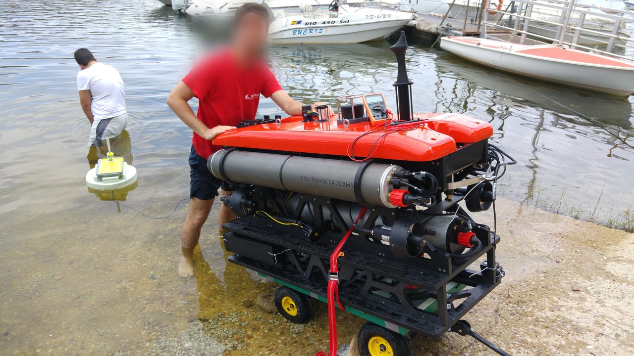 With one of the submarine robots at a reservoir field test near Madrid.